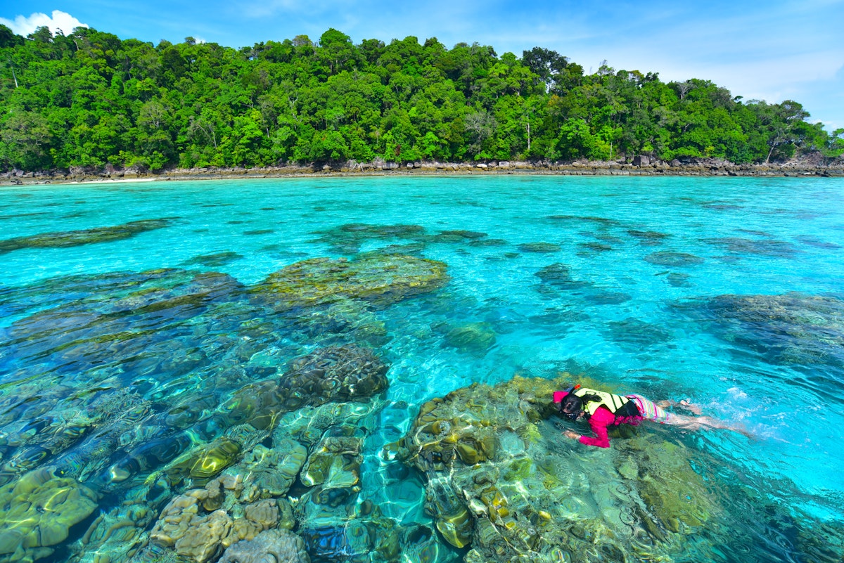 Snorkeling in clear water at Surin island.