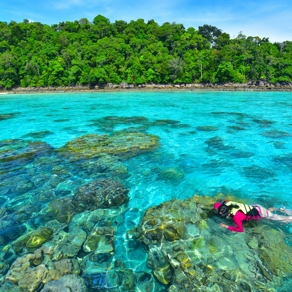 Snorkeling in clear water at Surin island.