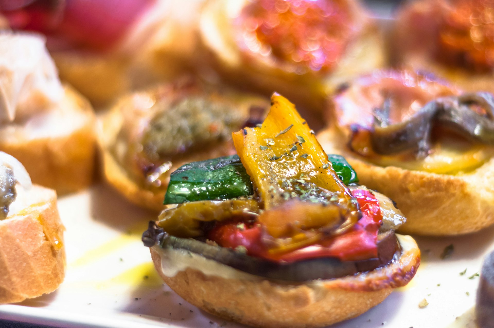 A close up of peppers on some bread, one of the traditional 'cicchetti' snacks in Venice.