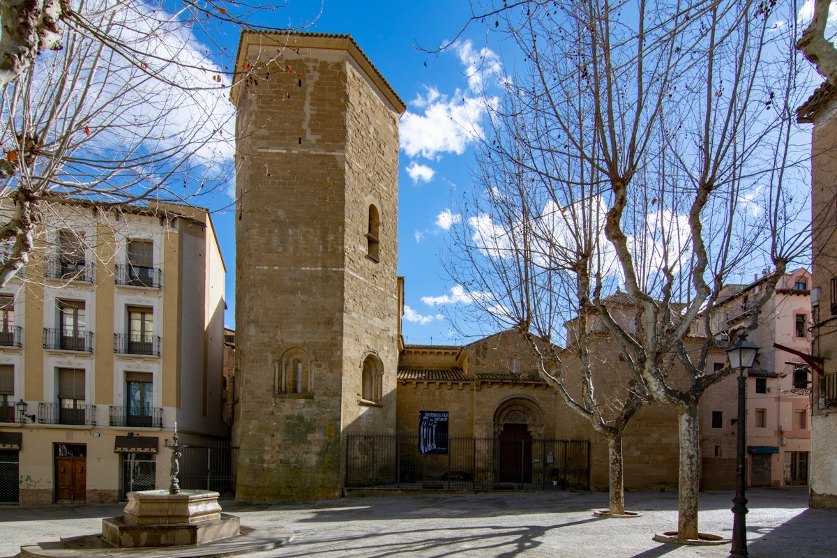 The bell tower and entrance of the church San Pedro in center historic of Huesca, Spain.