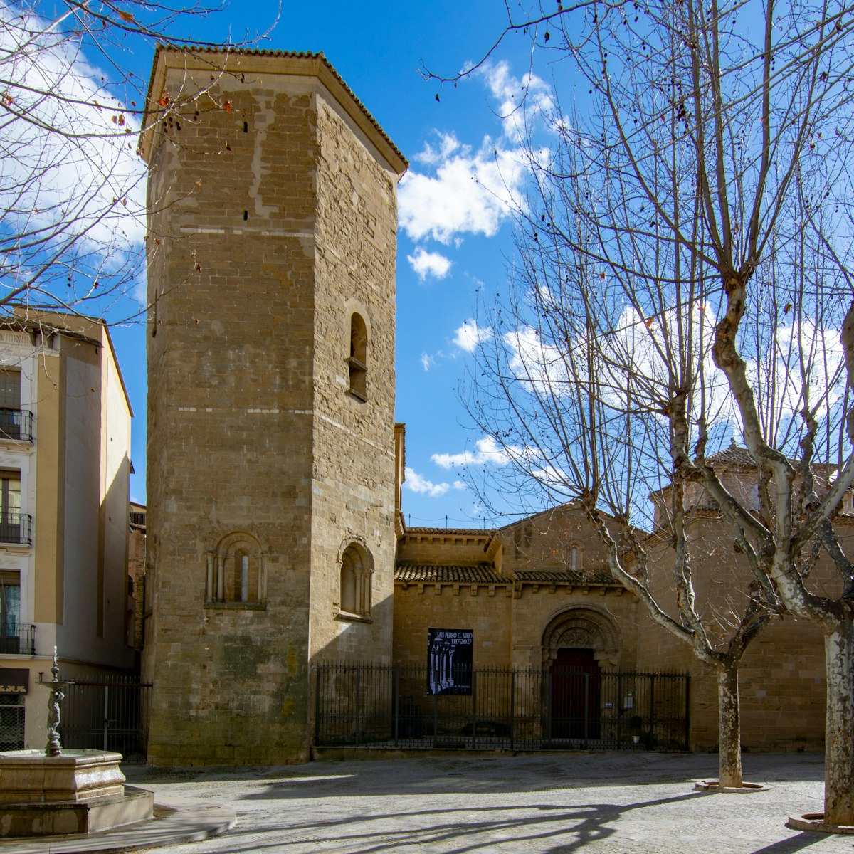 The bell tower and entrance of the church San Pedro in center historic of Huesca, Spain.