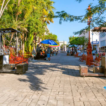 Rows of shoe shine booths at the Plaza Republica square outside the Church of Immaculate Conception in the historic old town of Mazatlan, Mexico.