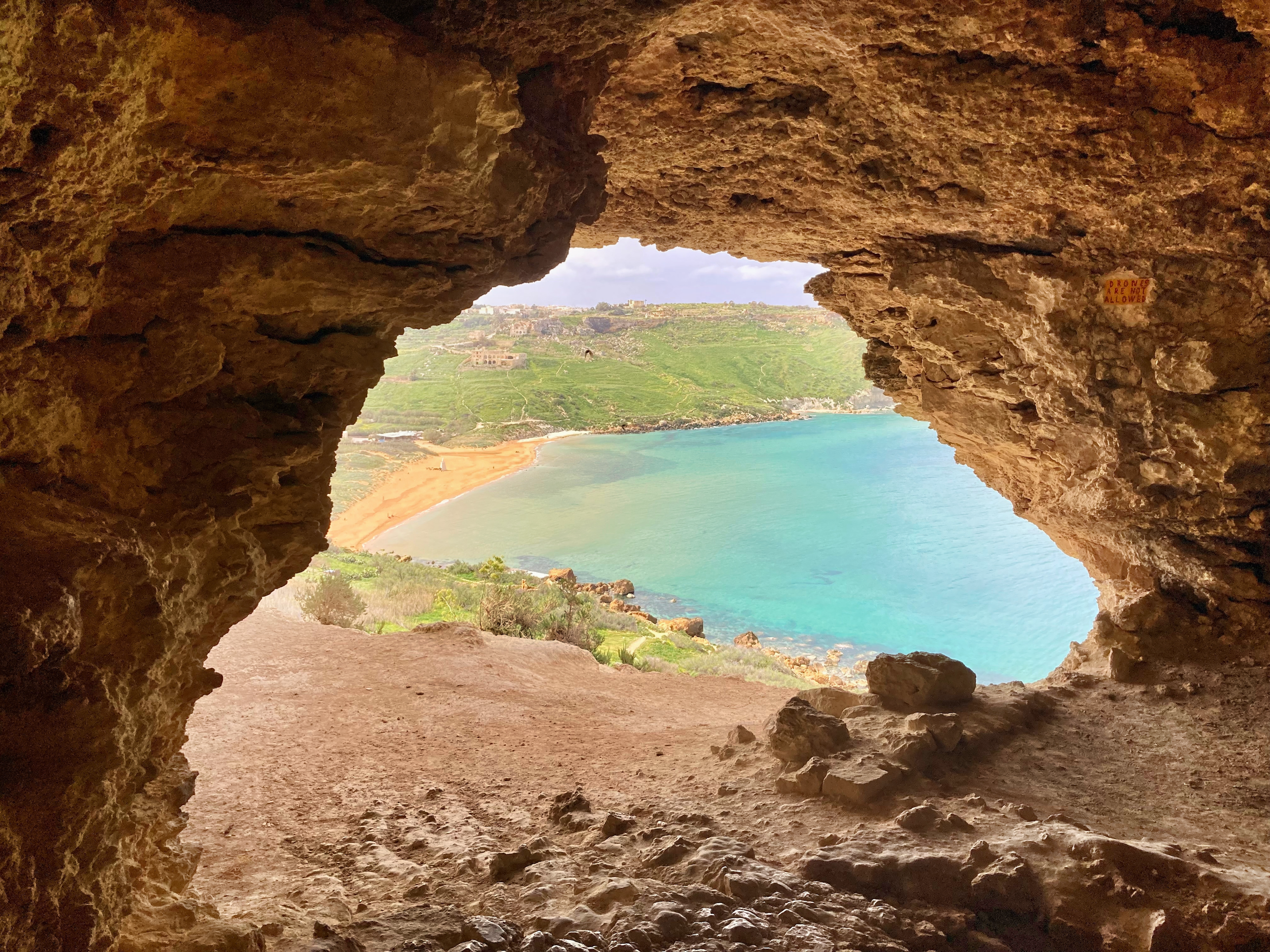 View of bay through lookout from Tal Mixta Cave in Gozo