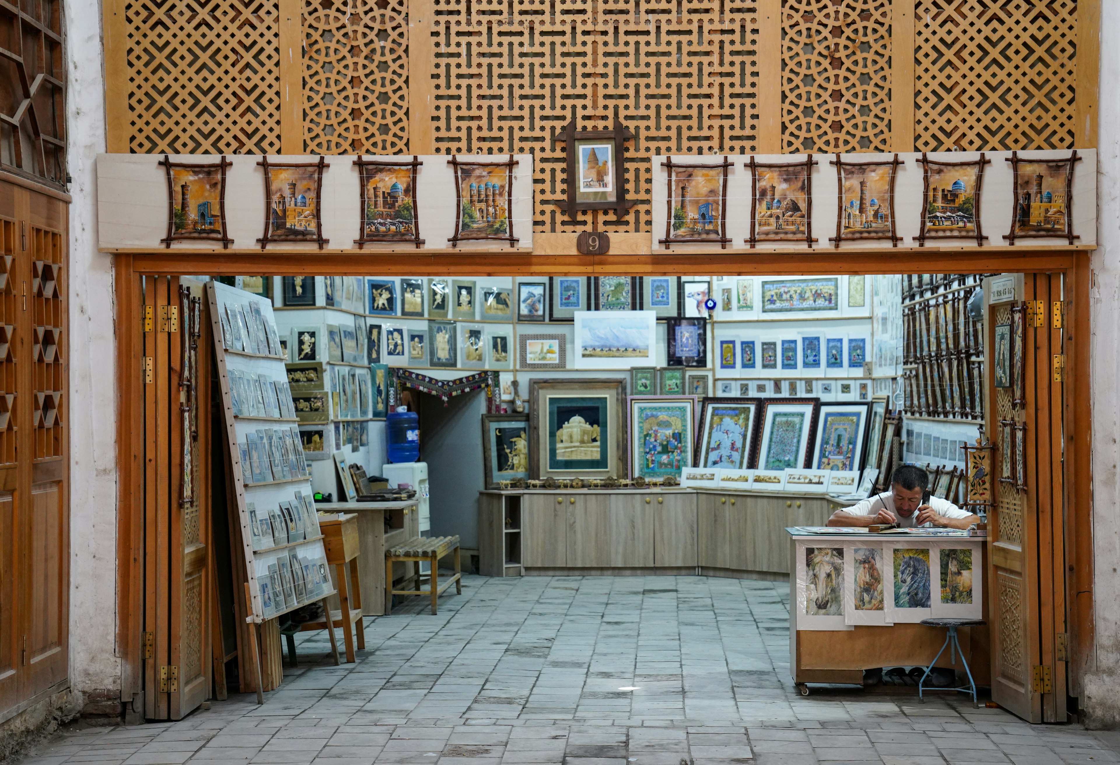 An artist at work in a souvenir market, Bukhara, Uzbekistan