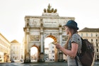 A tourist girl with a backpack looks sights in Munich in Germany. Passes by the triumphal arch.
1030263060
A woman with a backpack looks at sights in Munich, Germany. The victory arch is in the background.