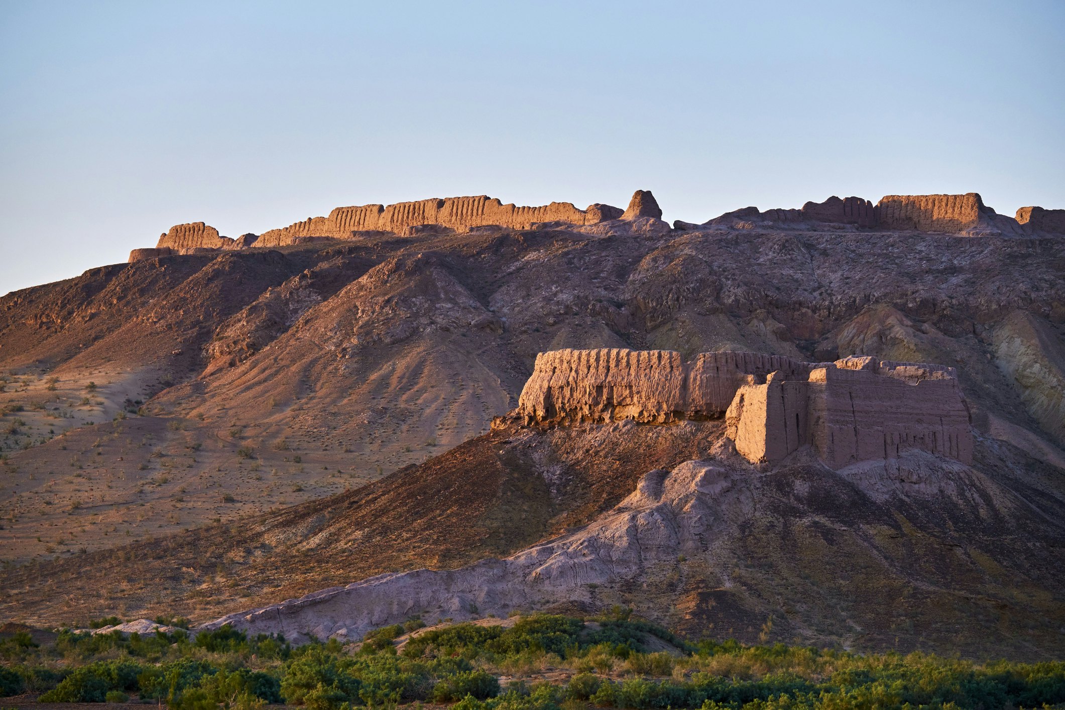 A sandstone fortress in the dusk on a hilltop in Uzbekistan, Karakalpakstan province, desert citadel, Ayaz Kala