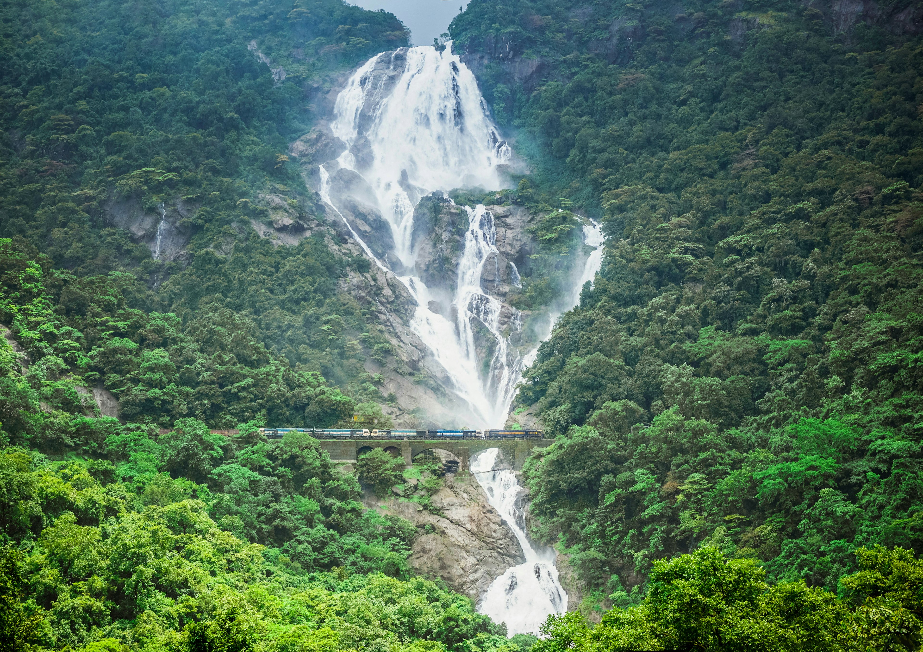 A Goa Express train passes the Dudhsagar Waterfall, Goa, India