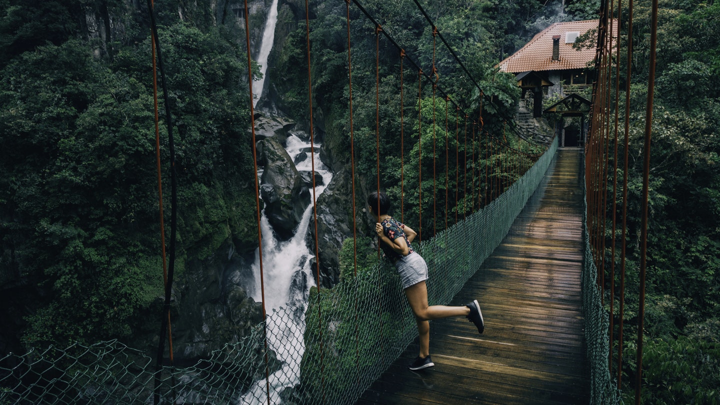 Woman wearing shorts on a suspension bridge looking to a waterfall in Ecuador. Self-Portrait catch-all release.
1167062305
A woman looking over the side of a suspension bridge at a waterfall in Ecuador