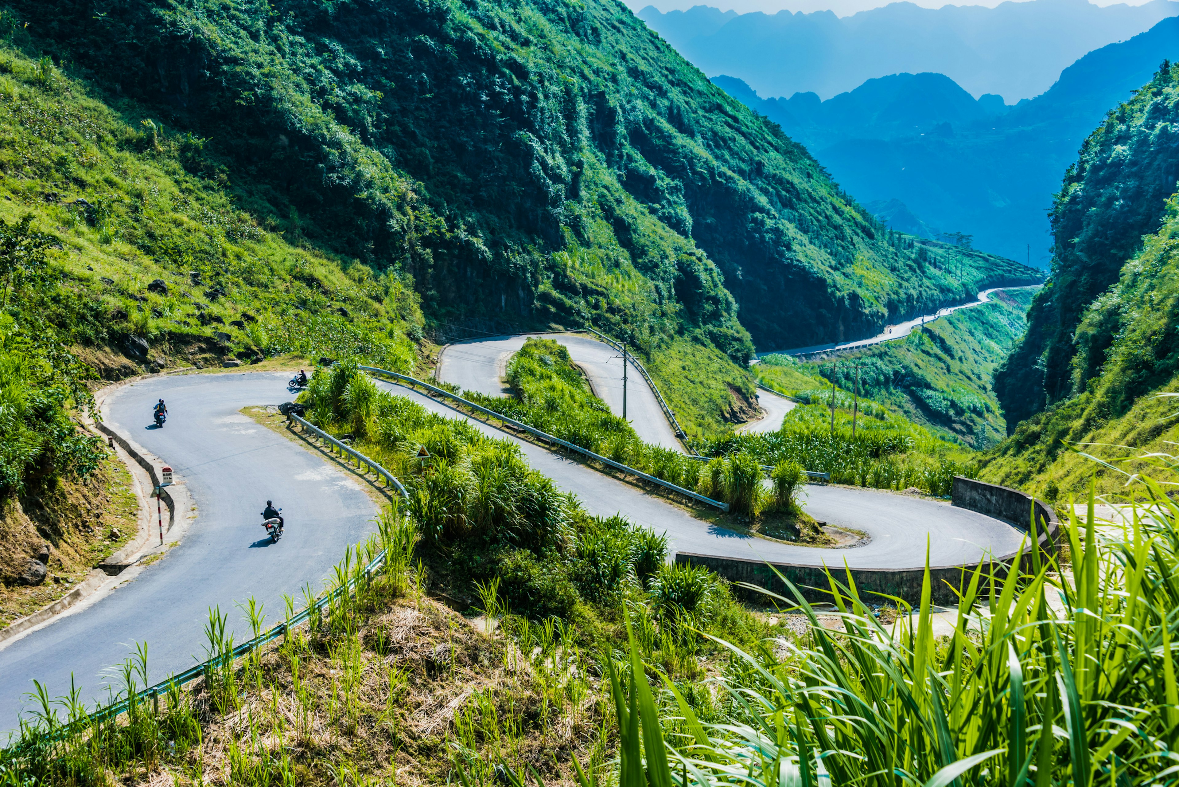 A winding switchback road in the lush green Ha Giang province in Vietnam