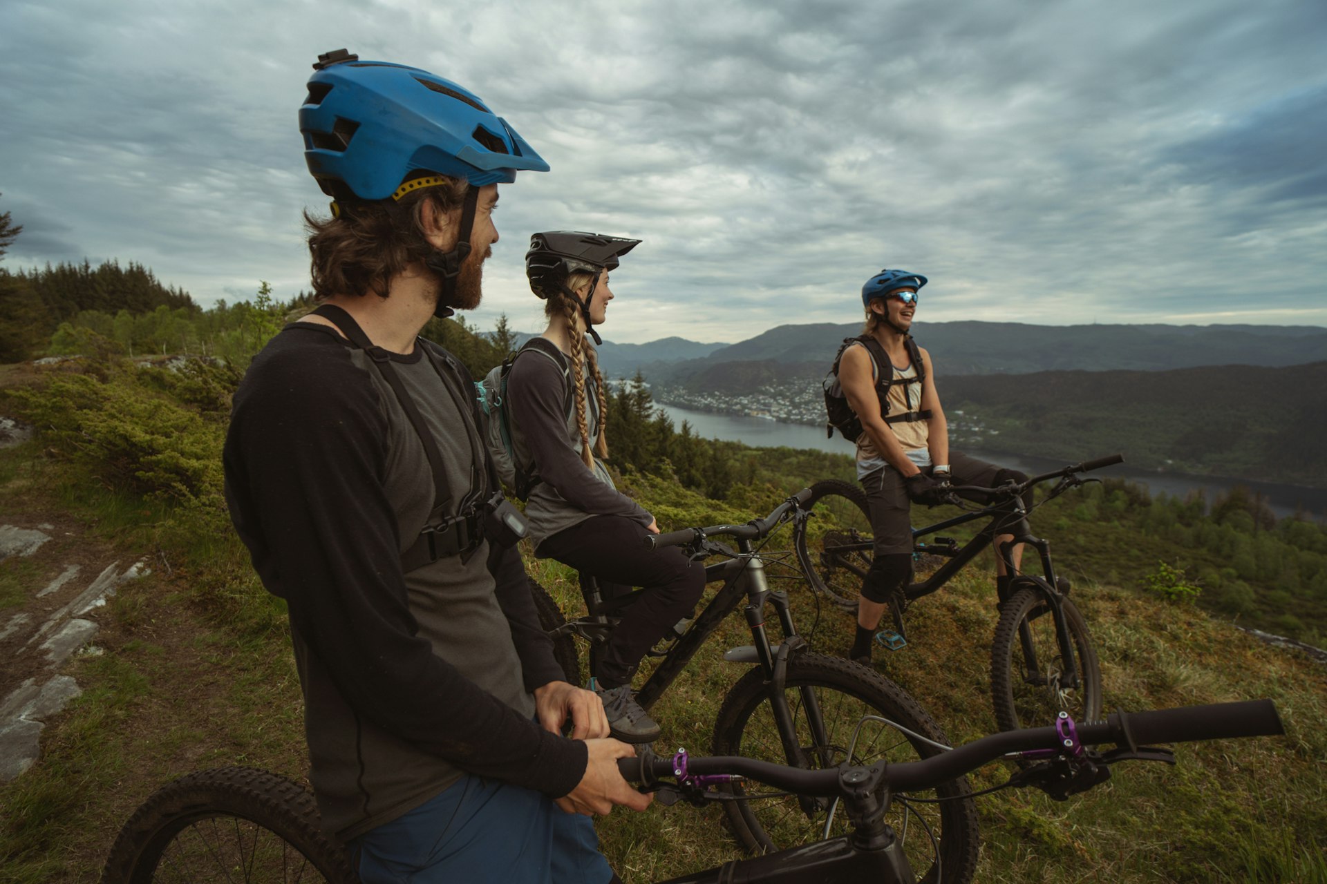 Group of three friends riding mountain-bikes on a mountain top