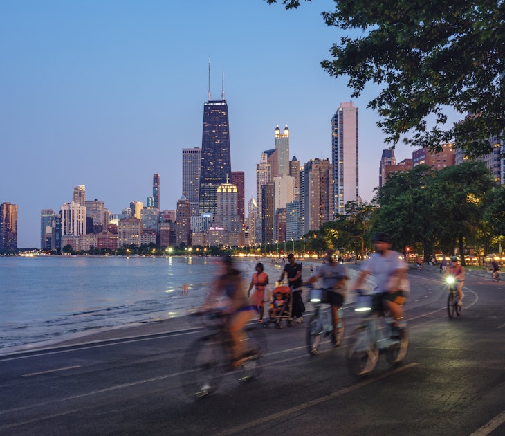 People riding bicycles at night with Chicago skyline in background
1251830172