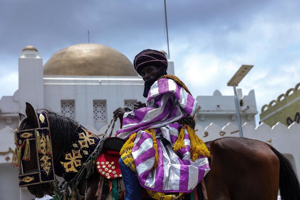 A horseman rides past the Emir's Palace during the Durbar Festival in Ilorin