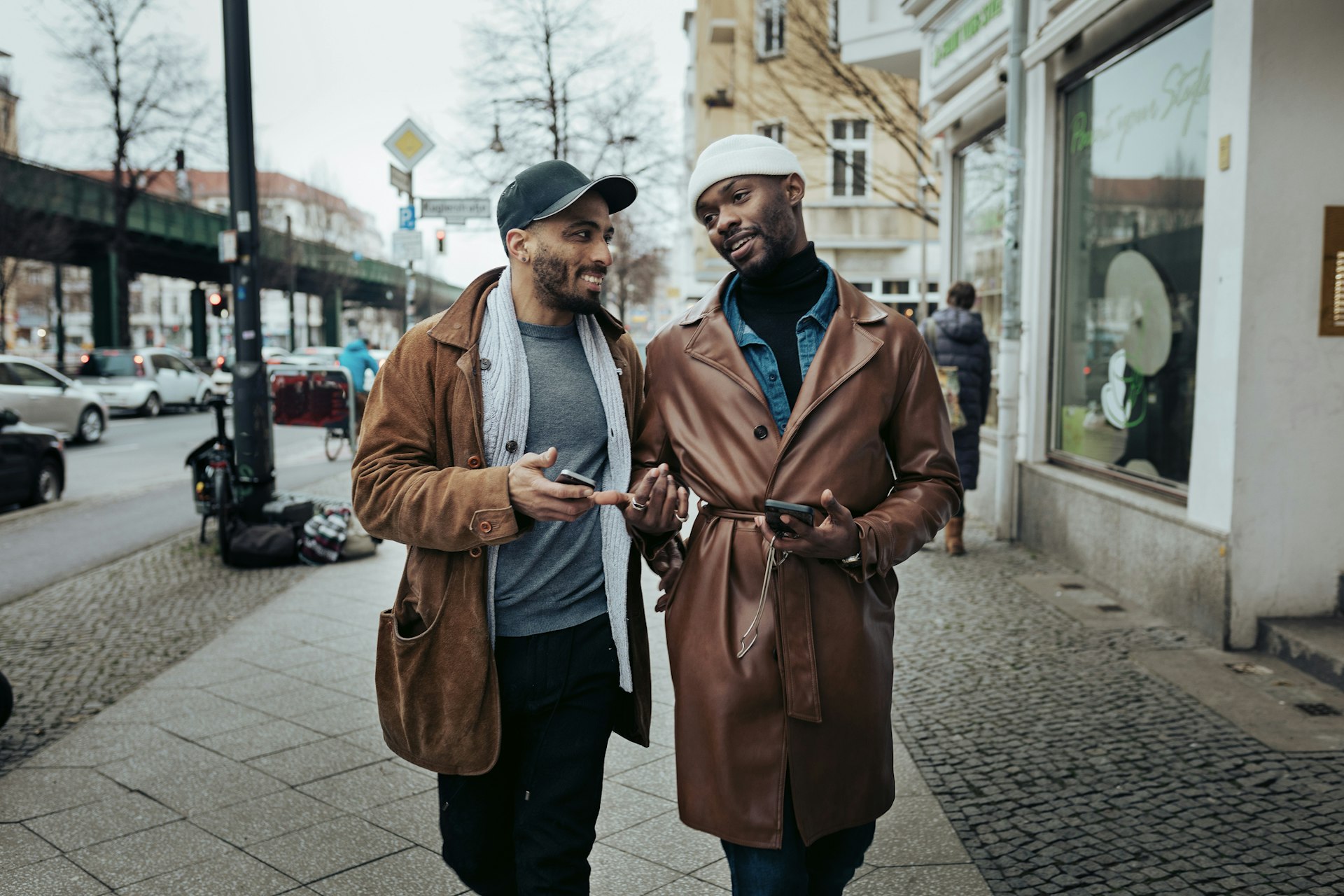 Two men walking down the street together in Berlin