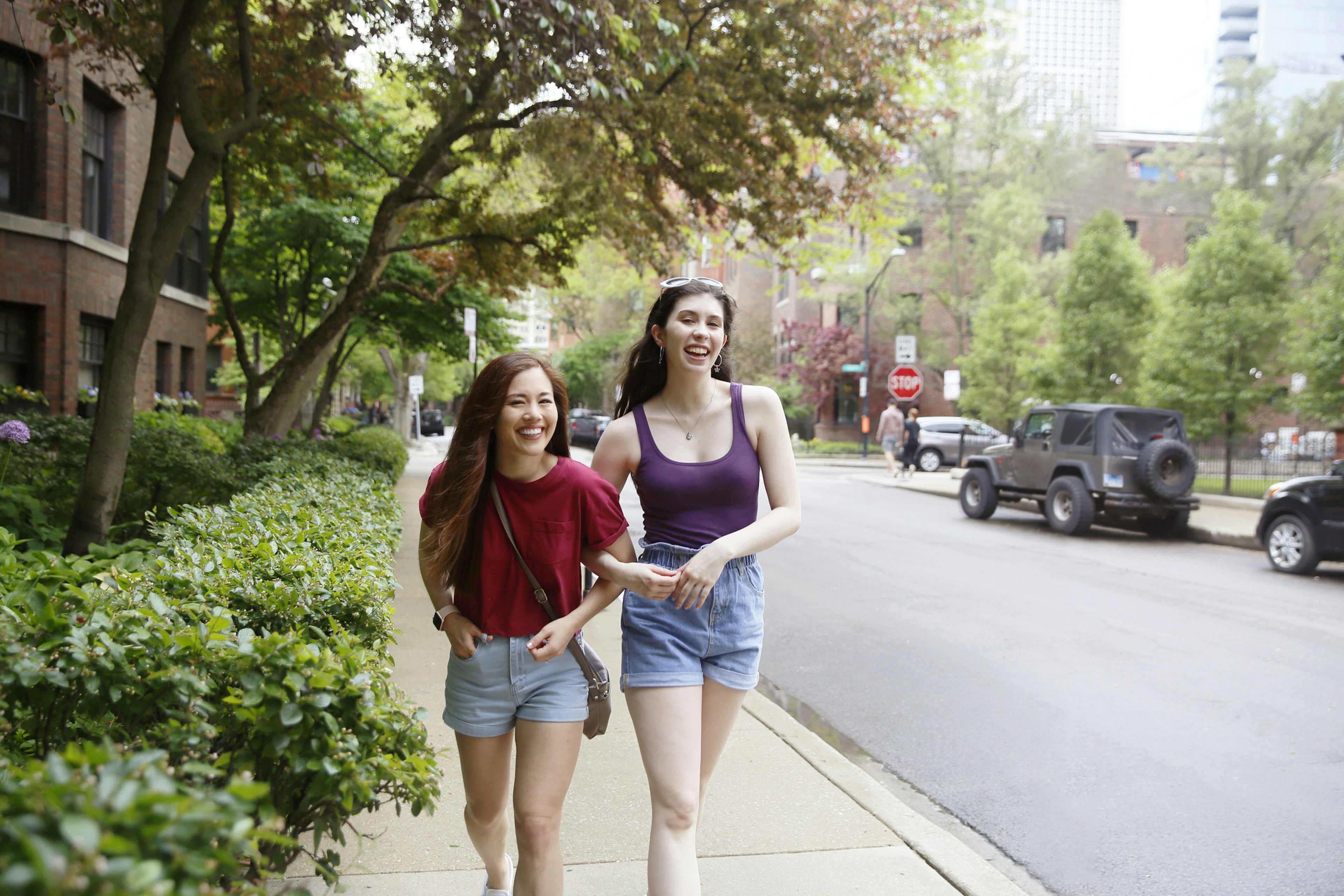 Two young women walking arm-in-arm in Chicago