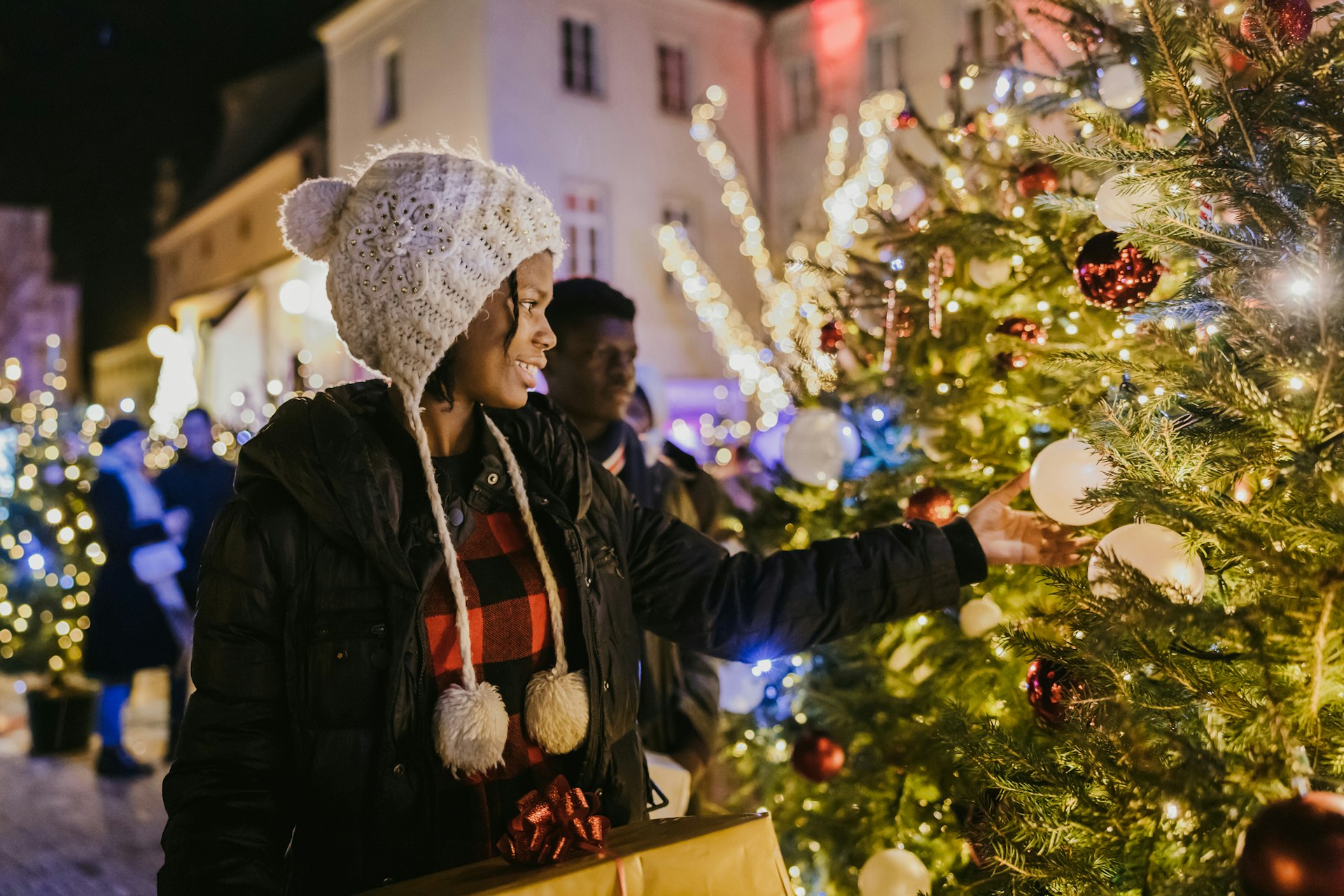 A woman looking at a Christmas tree in a festive market in Croatia