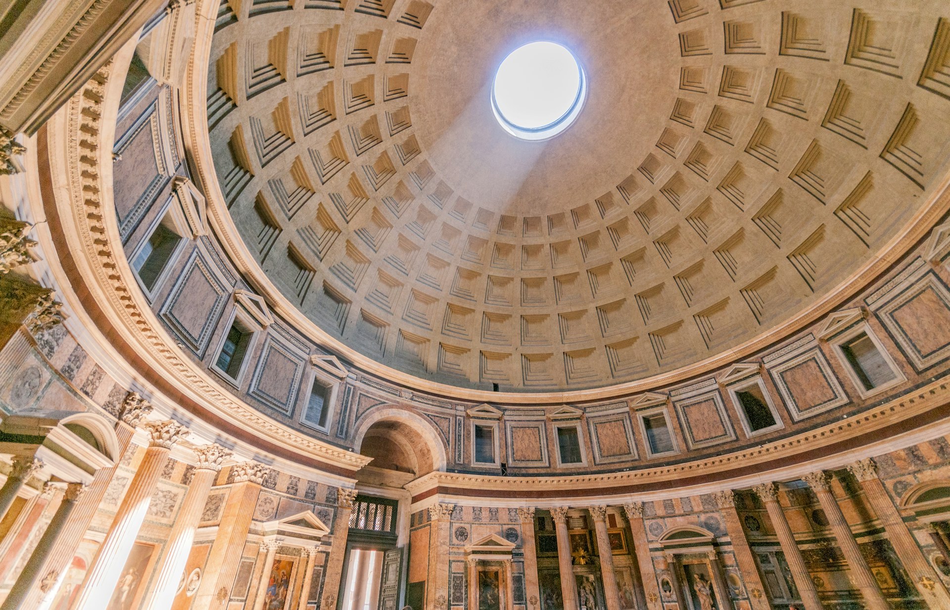Interior photo of Rome's Pantheon shows the detail of the dome and its surrounding features.