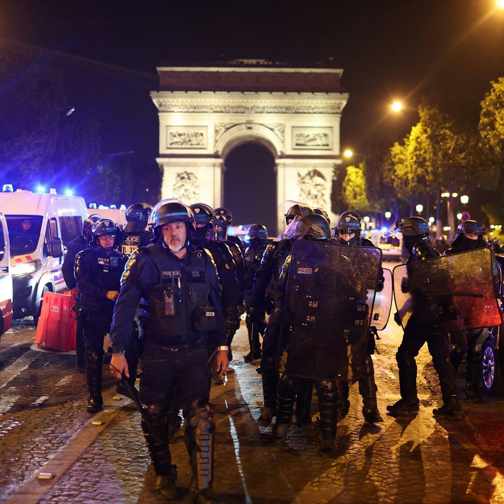TOPSHOT - French police officers patrol in front of the Arc de Triomphe in the Champs Elysees area of Paris on July 1, 2023, five days after a 17-year-old man was killed by police in Nanterre, a western suburb of Paris. French police arrested 1311 people nationwide during a fourth consecutive night of rioting over the killing of a teenager by police, the interior ministry said on July 1, 2023. France had deployed 45,000 officers overnight backed by light armoured vehicles and crack police units to quell the violence over the death of 17-year-old Nahel, killed during a traffic stop in a Paris suburb on June 27, 2023. (Photo by CHARLY TRIBALLEAU / AFP) (Photo by CHARLY TRIBALLEAU/AFP via Getty Images)
1379708303
demonstration, unrest, police, riot, Horizontal