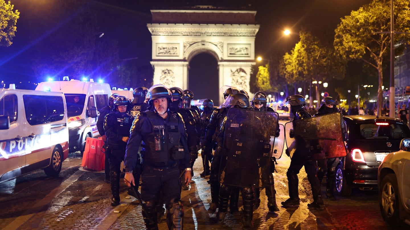 TOPSHOT - French police officers patrol in front of the Arc de Triomphe in the Champs Elysees area of Paris on July 1, 2023, five days after a 17-year-old man was killed by police in Nanterre, a western suburb of Paris. French police arrested 1311 people nationwide during a fourth consecutive night of rioting over the killing of a teenager by police, the interior ministry said on July 1, 2023. France had deployed 45,000 officers overnight backed by light armoured vehicles and crack police units to quell the violence over the death of 17-year-old Nahel, killed during a traffic stop in a Paris suburb on June 27, 2023. (Photo by CHARLY TRIBALLEAU / AFP) (Photo by CHARLY TRIBALLEAU/AFP via Getty Images)
1379708303
demonstration, unrest, police, riot, Horizontal