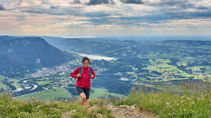 nice senior woman hiking at Mount Gruenten in the Allgaeu Alps with awesome view over Iller valley to Lake Alpsee and Lake of Constanz, Bodensee,  Bavaria, Germany
1409702721