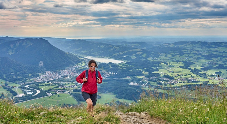nice senior woman hiking at Mount Gruenten in the Allgaeu Alps with awesome view over Iller valley to Lake Alpsee and Lake of Constanz, Bodensee,  Bavaria, Germany
1409702721