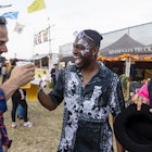 Group of mixed age and ethnic male friends having fun at a festival in Northumberland, North East England. They are laughing and drinking beer together, toasting their pints.
1457658884