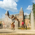 Families and tourists relax in the garden of the Rijksmuseum, the fountain forms an attraction in itself, inviting the old and young to interact with it, occassionaly resulting in wet clothes. People rushing in and out of the water spray.
509788919
Carefree, Fun, Joy, Playful, Togetherness
The Rijksmuseum garden with fountain - stock photo
Families and tourists relax in the garden of the Rijksmuseum, the fountain forms an attraction in itself, inviting the old and young to interact with it, occassionaly resulting in wet clothes. People rushing in and out of the water spray.