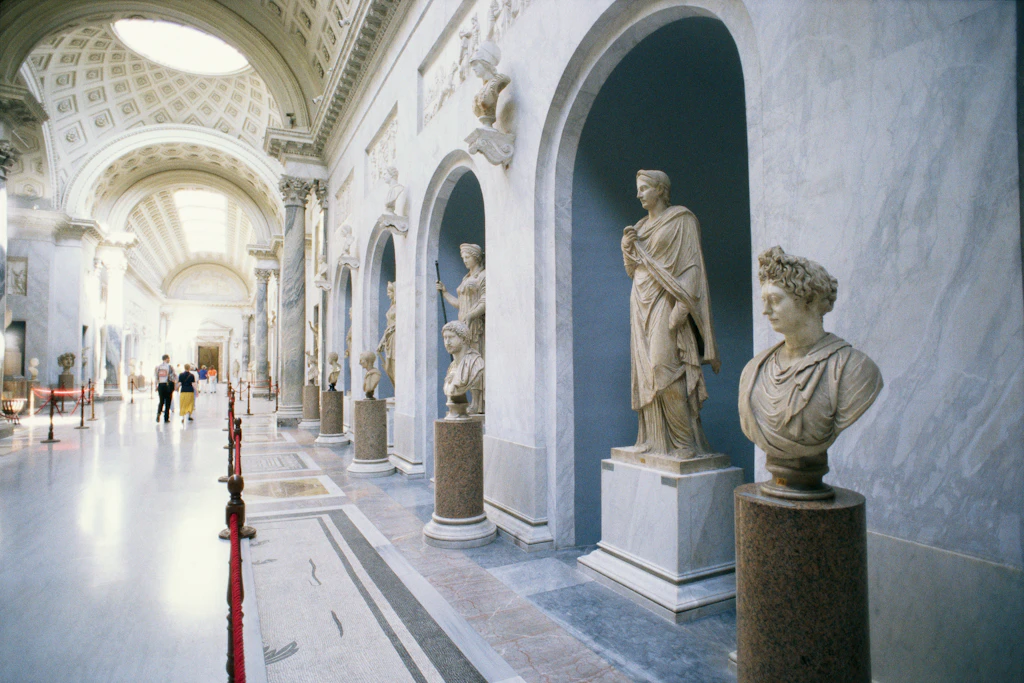 The interior of a gallery in the Vatican museums lined with sculptures