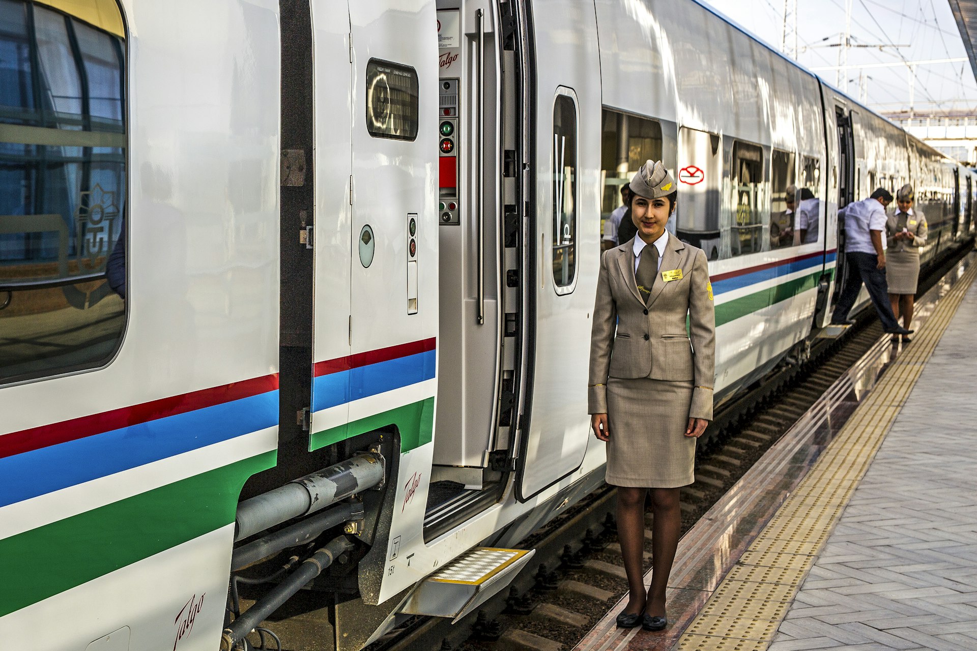 Female train conductor by the Afrosiyob train door