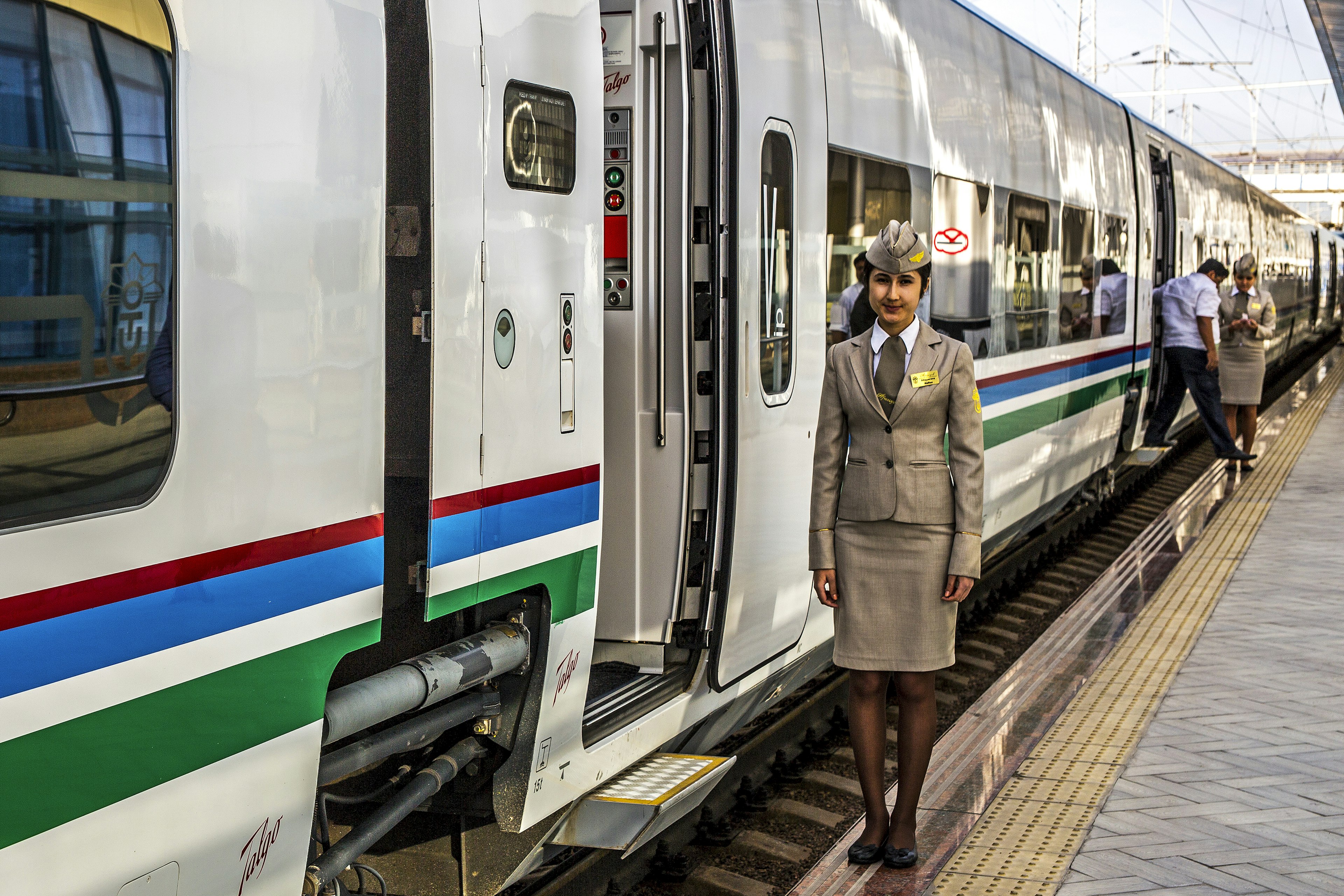 Female train conductor by the Afrosiyob train door