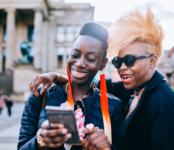 Happy friends using mobile phone in Berlin City.
957556544
Two black women laughing together while looking at a phone in Berlin
