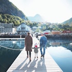 Family walking on a pier on a sunny day in Norway.
1091223354
Outdoors, Transportation, Bonding, Photography, Tree, Leisure Activity, Part of a Series, Lifestyles, Pier, Adult, Girls, Sky, Blue, City, Family, Men, Nature, Daughter, Sunlight, Majestic, Exploration, 2-3 Years, Beauty, Connection, Vacations, Reflection, White Color, Senior Adult, Active Seniors, Mountain Range, Holding Hands, On The Move, Rear View, Females, Full Length, Nautical Vessel, Adventure, Young Women, Care, Weekend Activities, Travel, Getting Away From It All, Grandparent, Norway, Daughter - Band, Young Adult, 20-24 Years, Multi-Generation Family, Tranquility, People, Grandfather, Moored, Mother, 65-69 Years, Childhood, Mountain, Color Image, Day, Three People, Senior Men, Beauty In Nature, Togetherness, Father, Harbor, Warm Clothing, Child, Travel Destinations, Horizontal, Shadow, Walking