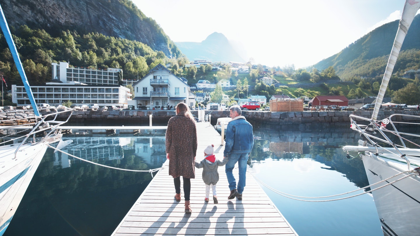 Family walking on a pier on a sunny day in Norway.
1091223354
Outdoors, Transportation, Bonding, Photography, Tree, Leisure Activity, Part of a Series, Lifestyles, Pier, Adult, Girls, Sky, Blue, City, Family, Men, Nature, Daughter, Sunlight, Majestic, Exploration, 2-3 Years, Beauty, Connection, Vacations, Reflection, White Color, Senior Adult, Active Seniors, Mountain Range, Holding Hands, On The Move, Rear View, Females, Full Length, Nautical Vessel, Adventure, Young Women, Care, Weekend Activities, Travel, Getting Away From It All, Grandparent, Norway, Daughter - Band, Young Adult, 20-24 Years, Multi-Generation Family, Tranquility, People, Grandfather, Moored, Mother, 65-69 Years, Childhood, Mountain, Color Image, Day, Three People, Senior Men, Beauty In Nature, Togetherness, Father, Harbor, Warm Clothing, Child, Travel Destinations, Horizontal, Shadow, Walking