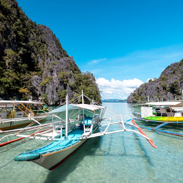 Banca boats in the water at Coron Island.
1134247260
Nature Travel Destinations Nautical Vessel Horizontal Outdoors Asia Philippines Passenger Craft Moored Water Water's Edge Landscape - Scenery Island Day Sea Beach Pacific Ocean Visayan Islands Palawan Tourboat Color Image Sulu Sea Beauty In Nature Incidental People Photography Nature Reserve Passenger Ship Travel Karst Formation Calamian Islands Ship Tradition