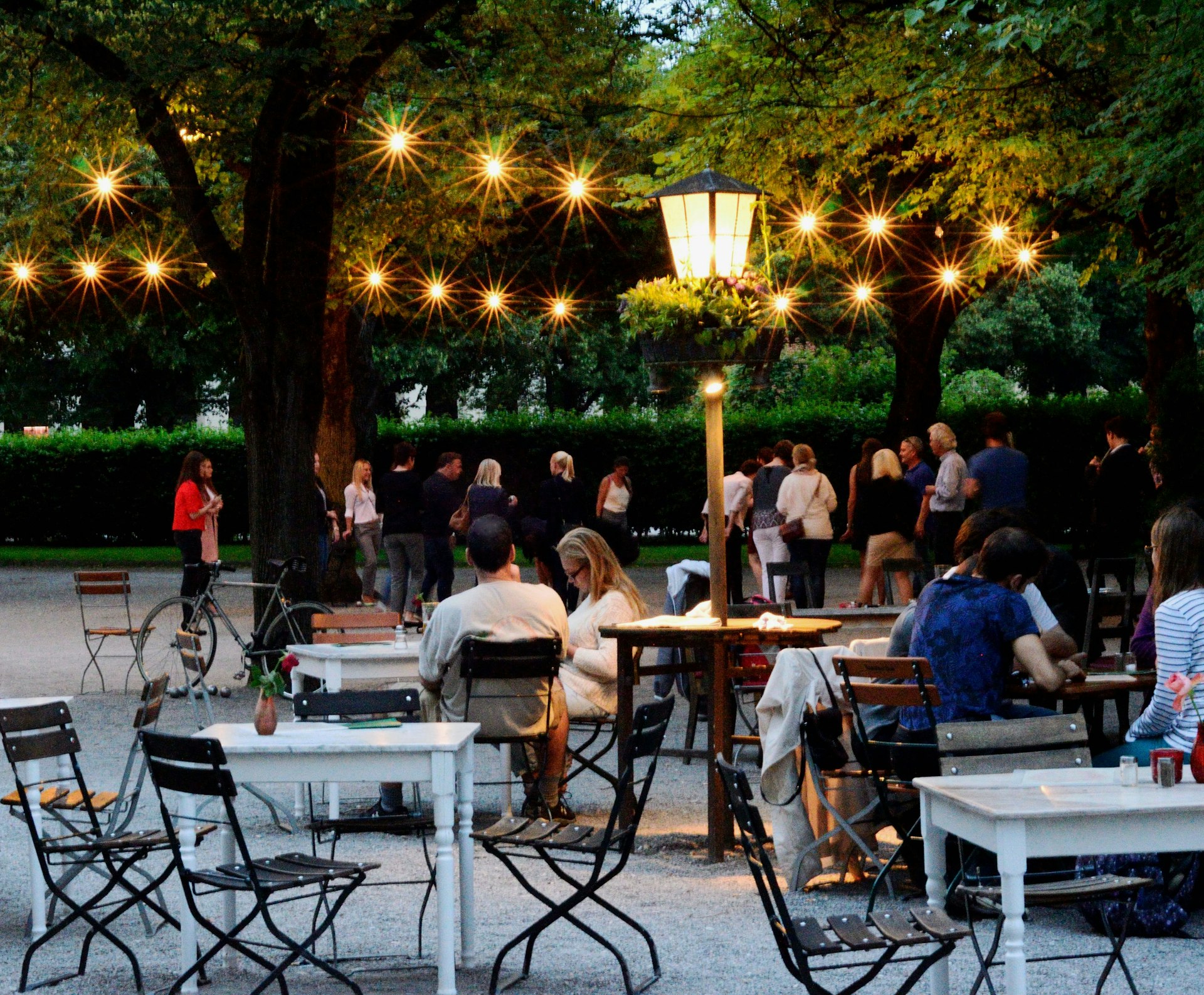 people drinking at an outdoor cafe in Munich in the evening