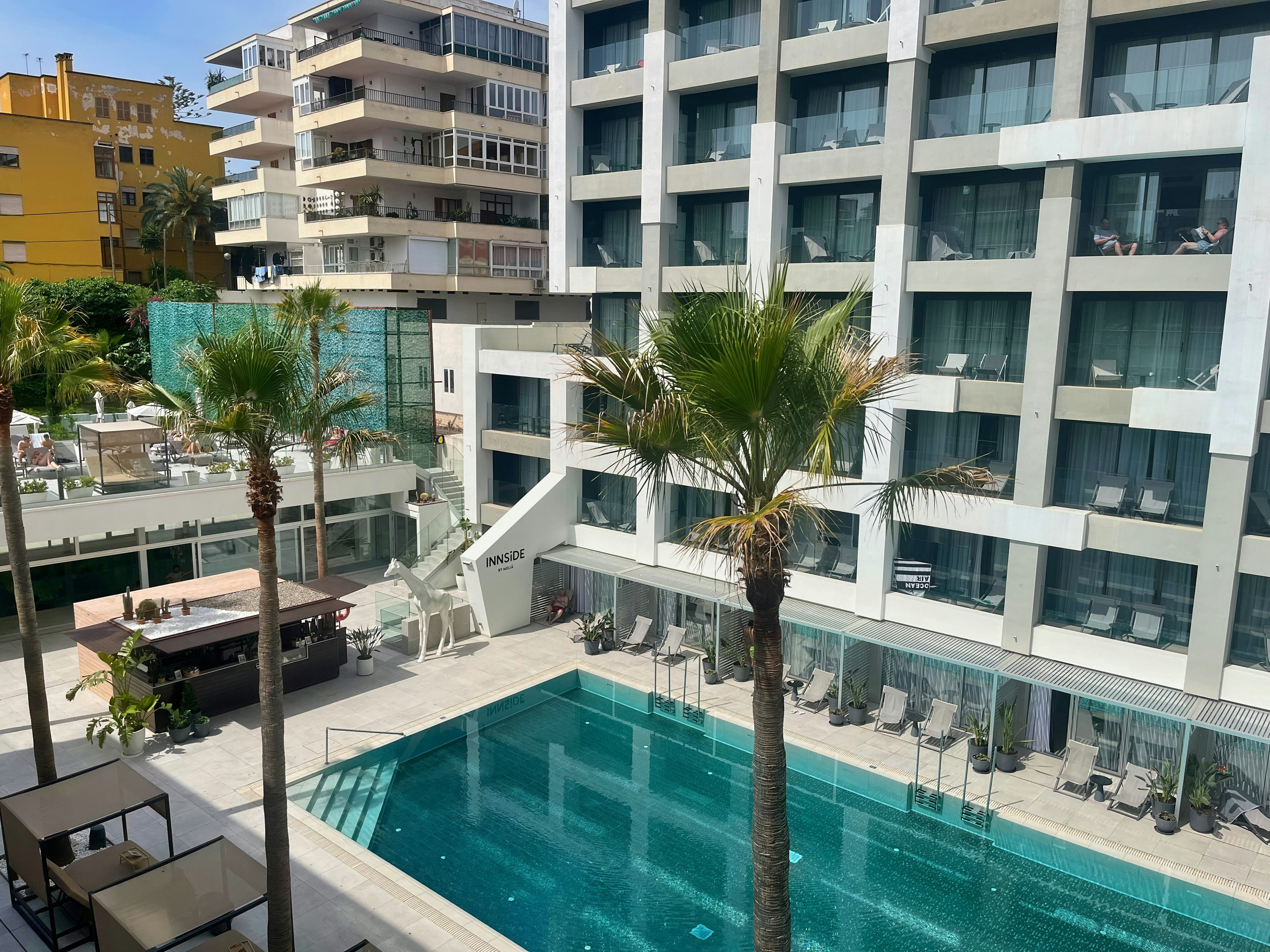 View of pool and sun loungers from balcony in hotel