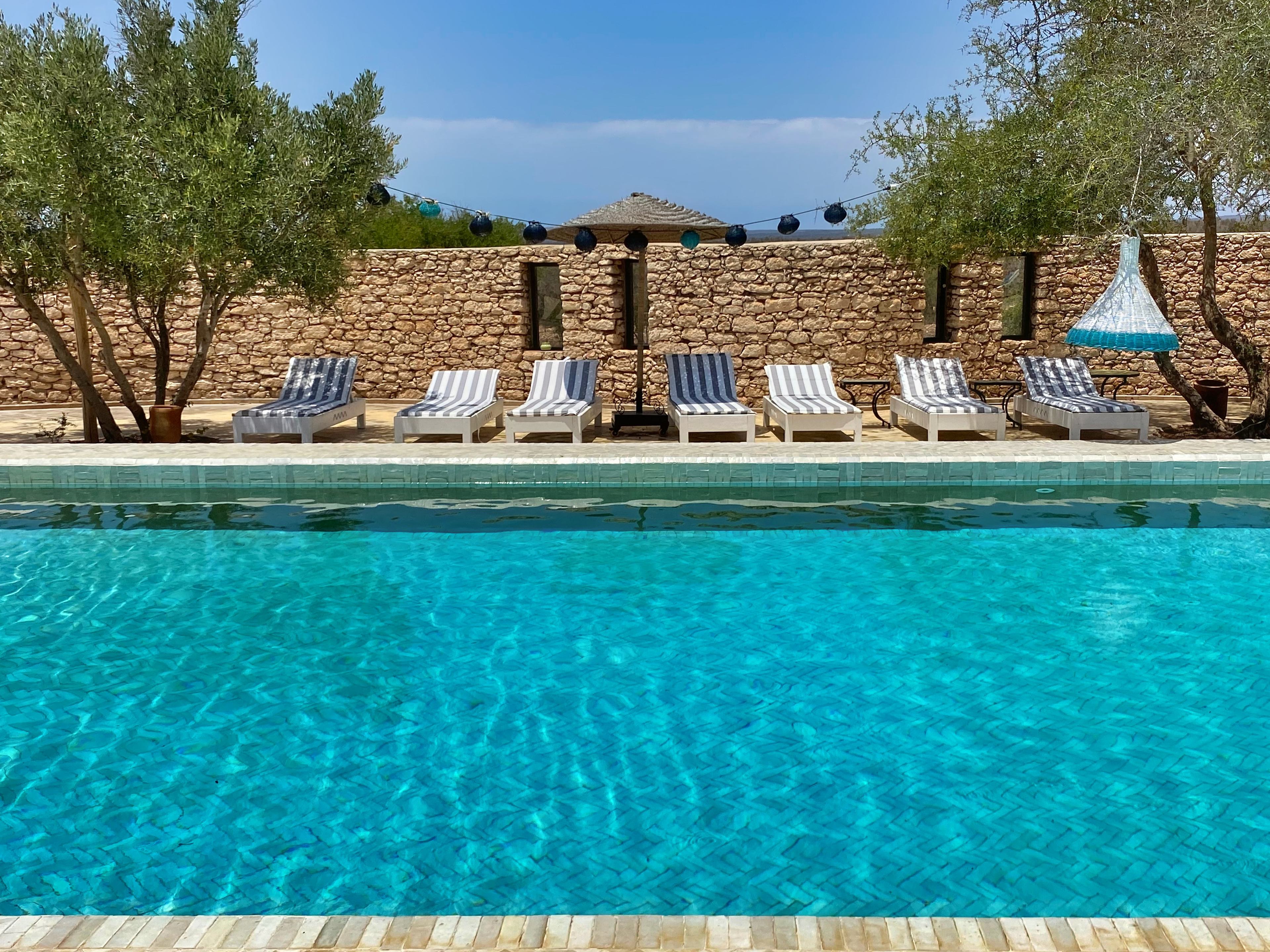 Pool and deckchairs at Jardins Villa