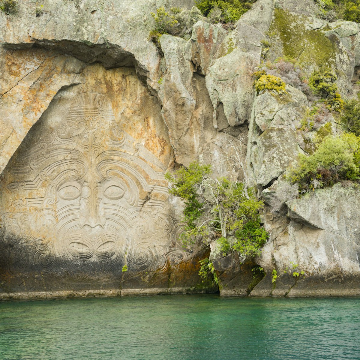 Maori rock carving at Mine Bay, Lake Taupo, North Island, New Zealand.