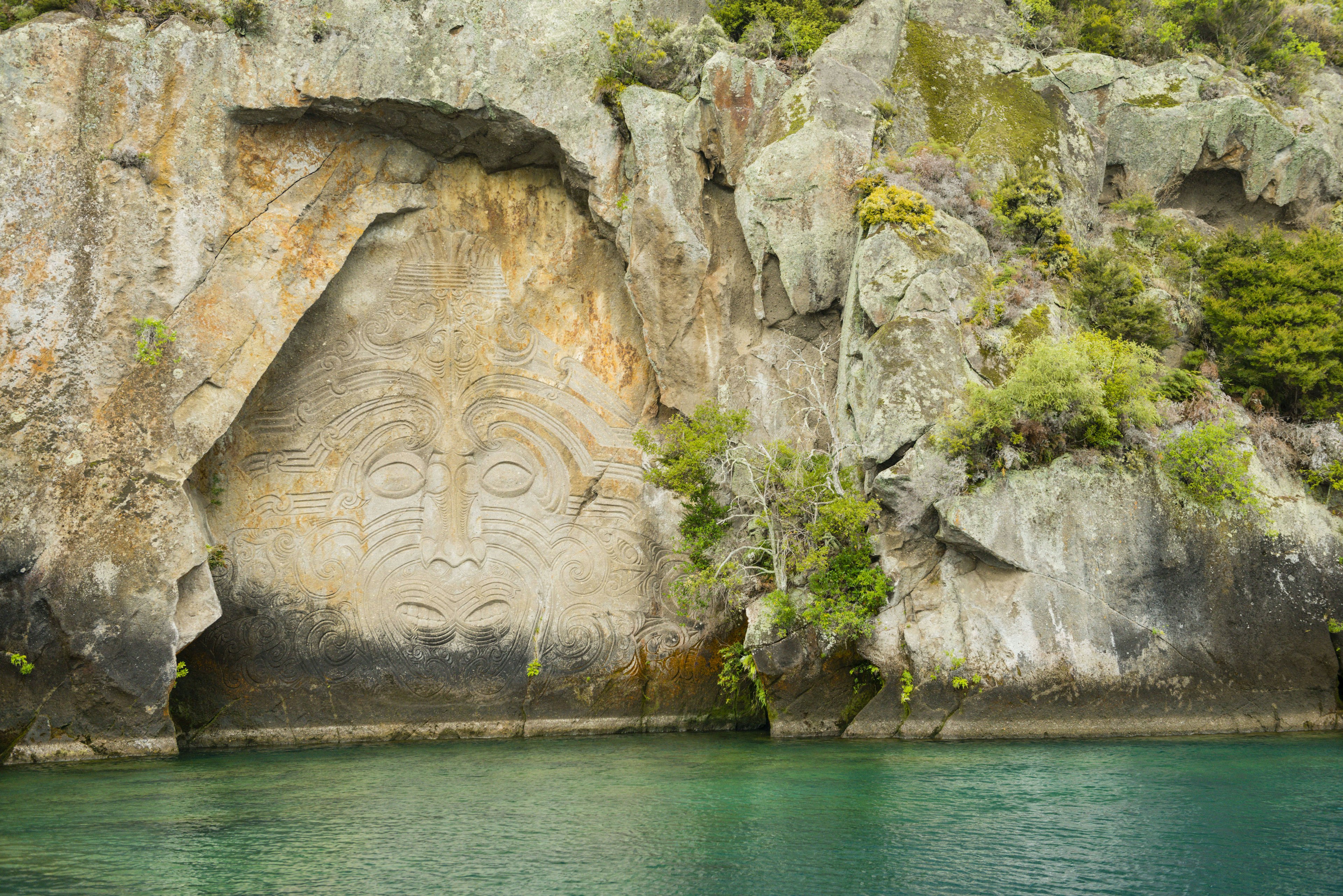 Maori rock carving at Mine Bay, Lake Taupo, North Island, New Zealand.