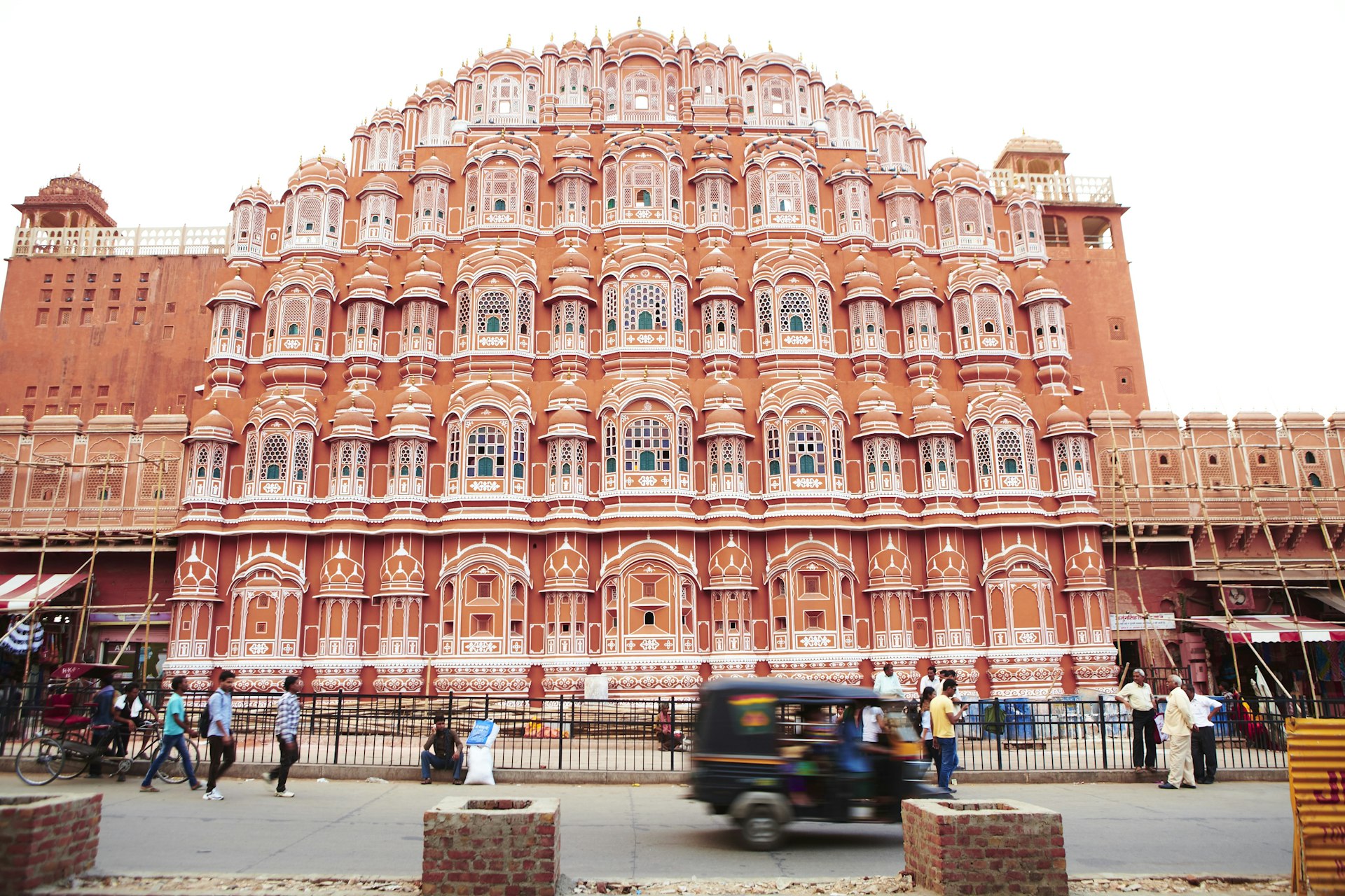 People pass the exterior of the Palace of Winds (Hawa Mahal), Jaipur, Rajasthan, India