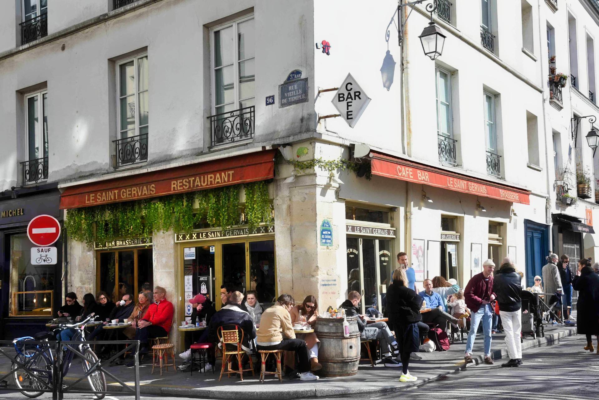 People dine on the terrace of Le Saint Gervais Paris on a sunny evening