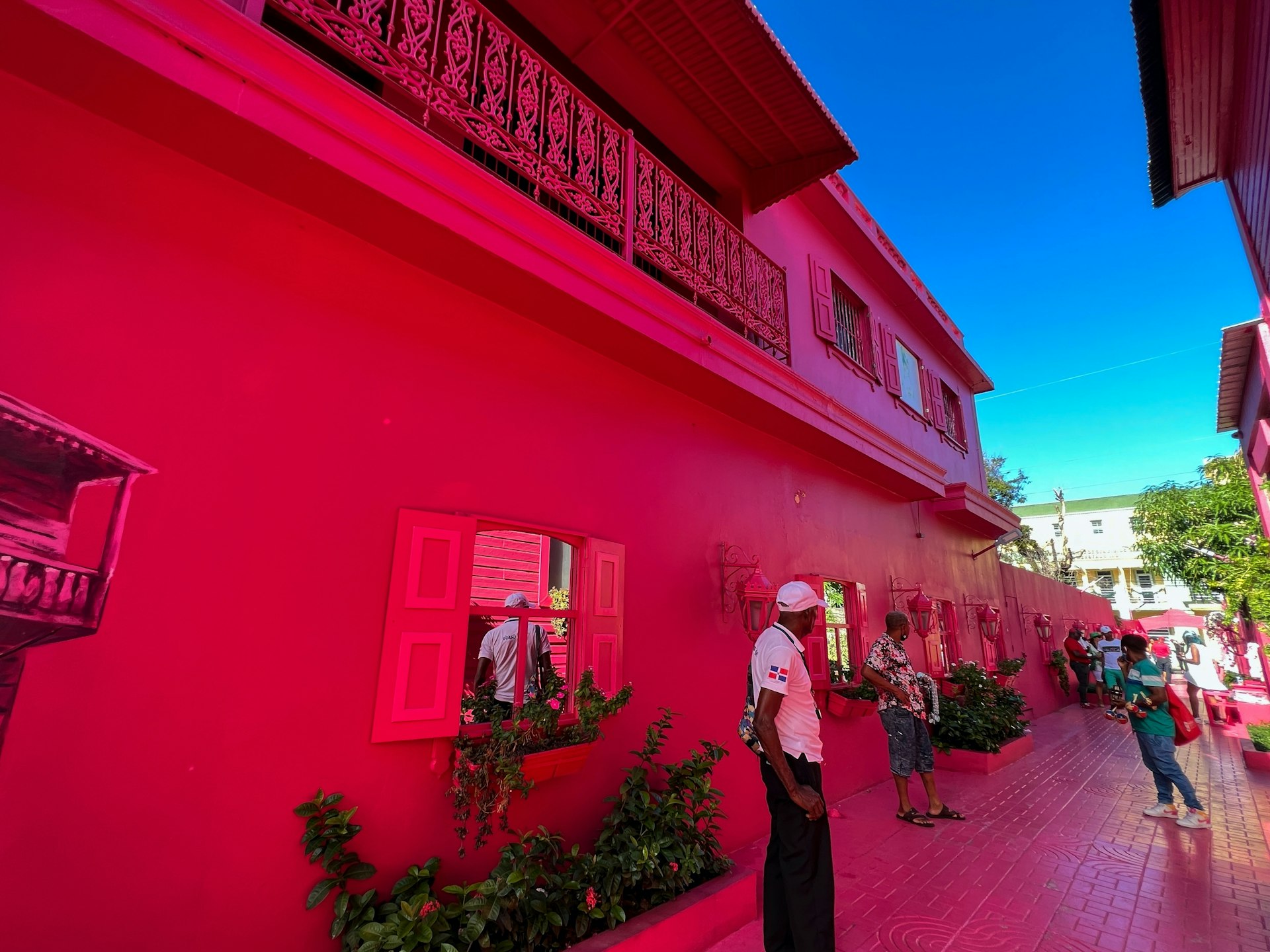 People playing and socializing on the Pink Street in Puerto Plata