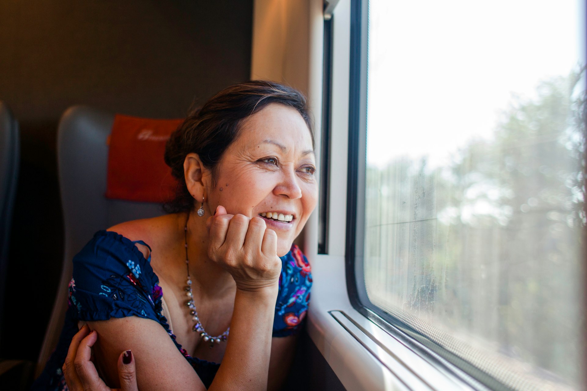 A tourist enjoys a train trip through Italy