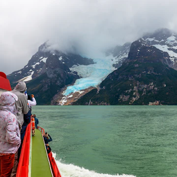 Tourists on a exploration cruise approaching the Balmaceda glacier on the Last Hope Sound, Bernardo O Higgins National Park, Patagonia, Chile.