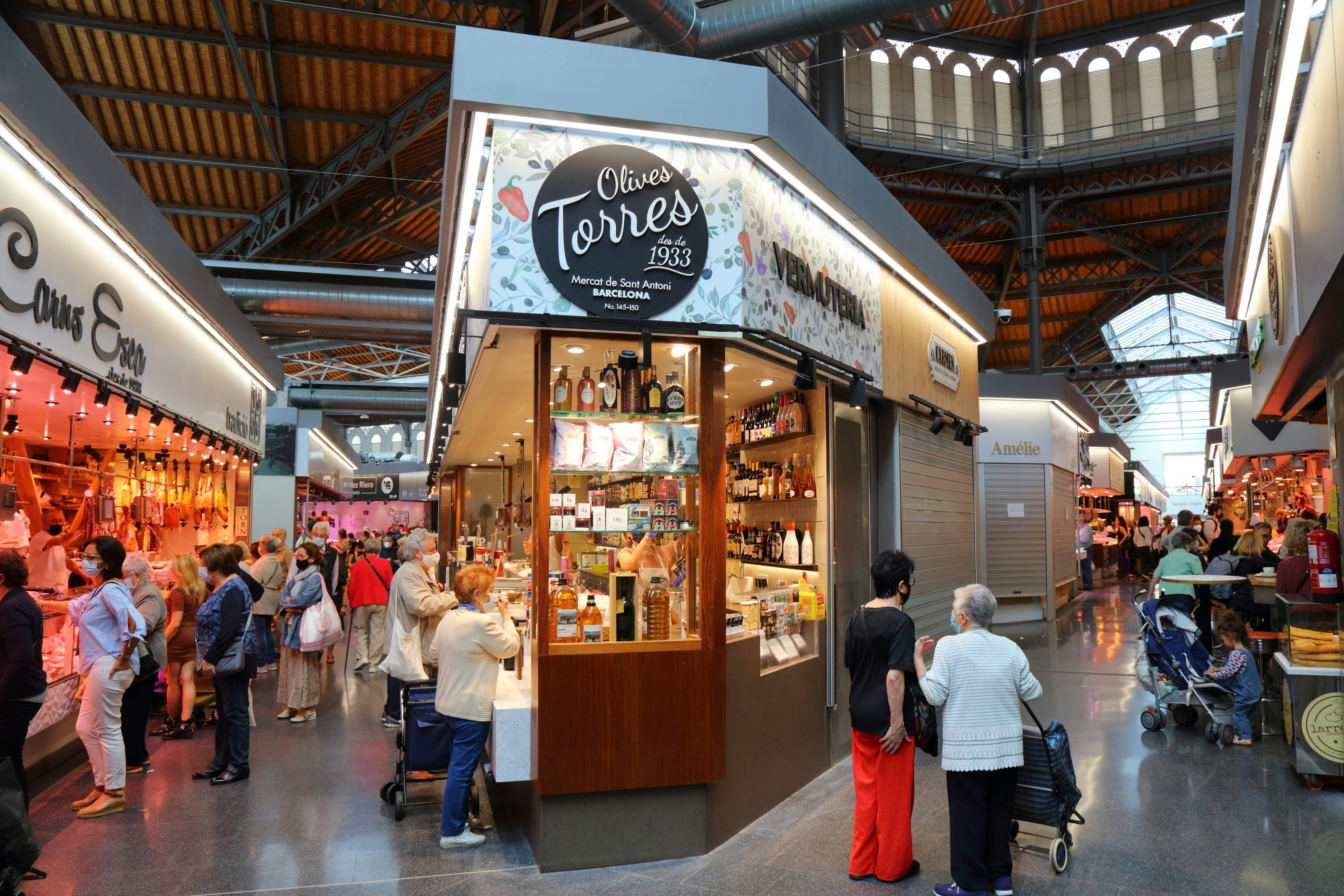 People visit the local market hall Mercat de Sant Antoni in Barcelona, Spain. @Tupungato/iStock