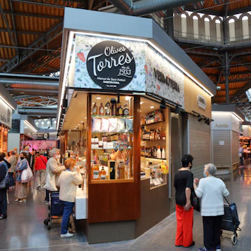People visit the local market hall Mercat de Sant Antoni in Barcelona, Spain. @Tupungato/iStock