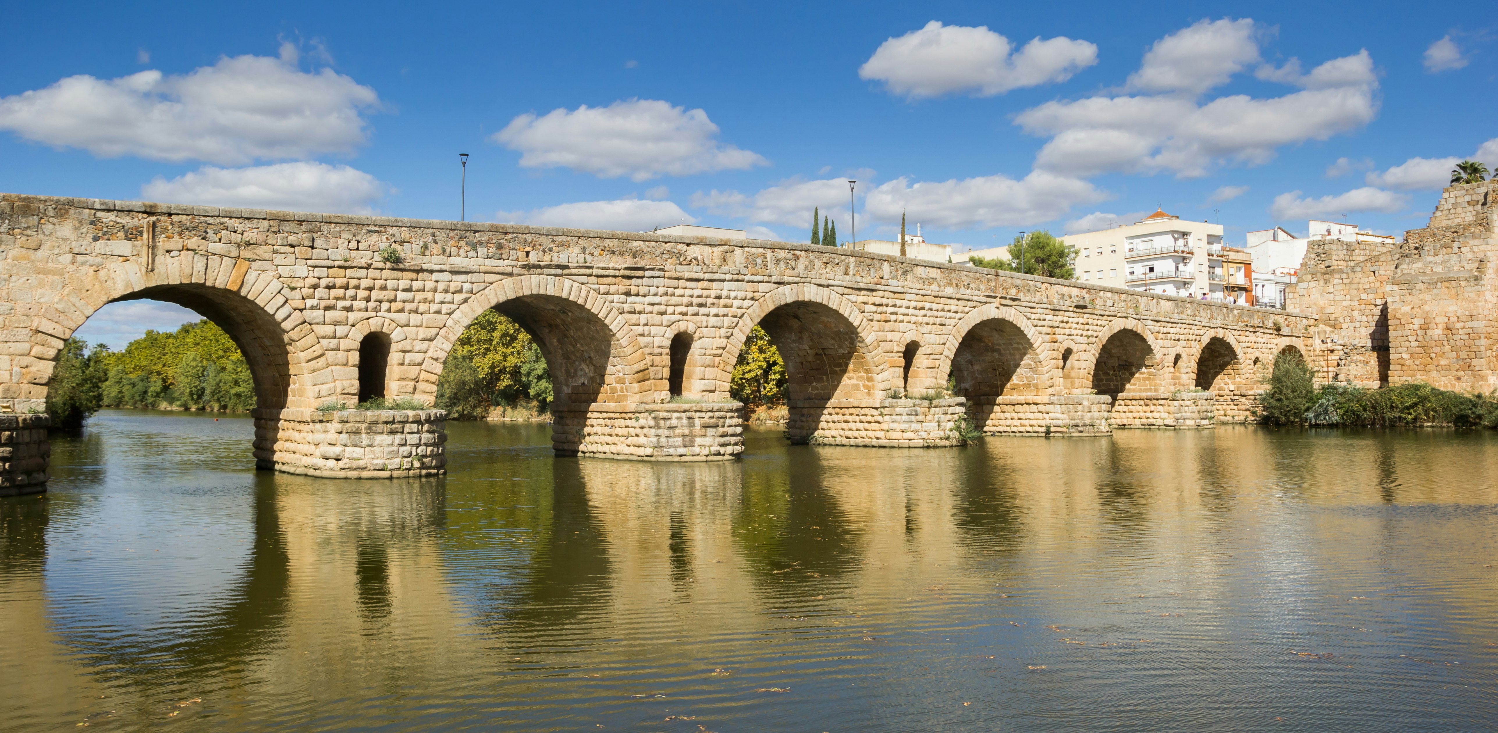 The historic roman bridge Puente Romana over the Guadiana river in Merida, Spain.