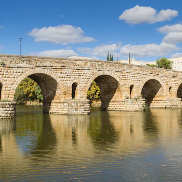 The historic roman bridge Puente Romana over the Guadiana river in Merida, Spain.