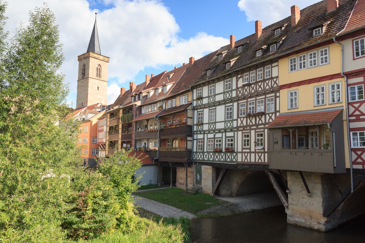 Medieval arch bridge Krämerbrücke crossing river Gera with half-timbered shops and houses in the city of Erfurt, Germany.