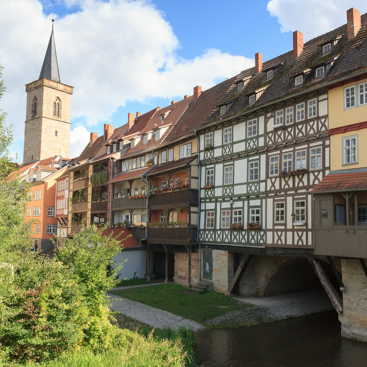 Medieval arch bridge Krämerbrücke crossing river Gera with half-timbered shops and houses in the city of Erfurt, Germany.