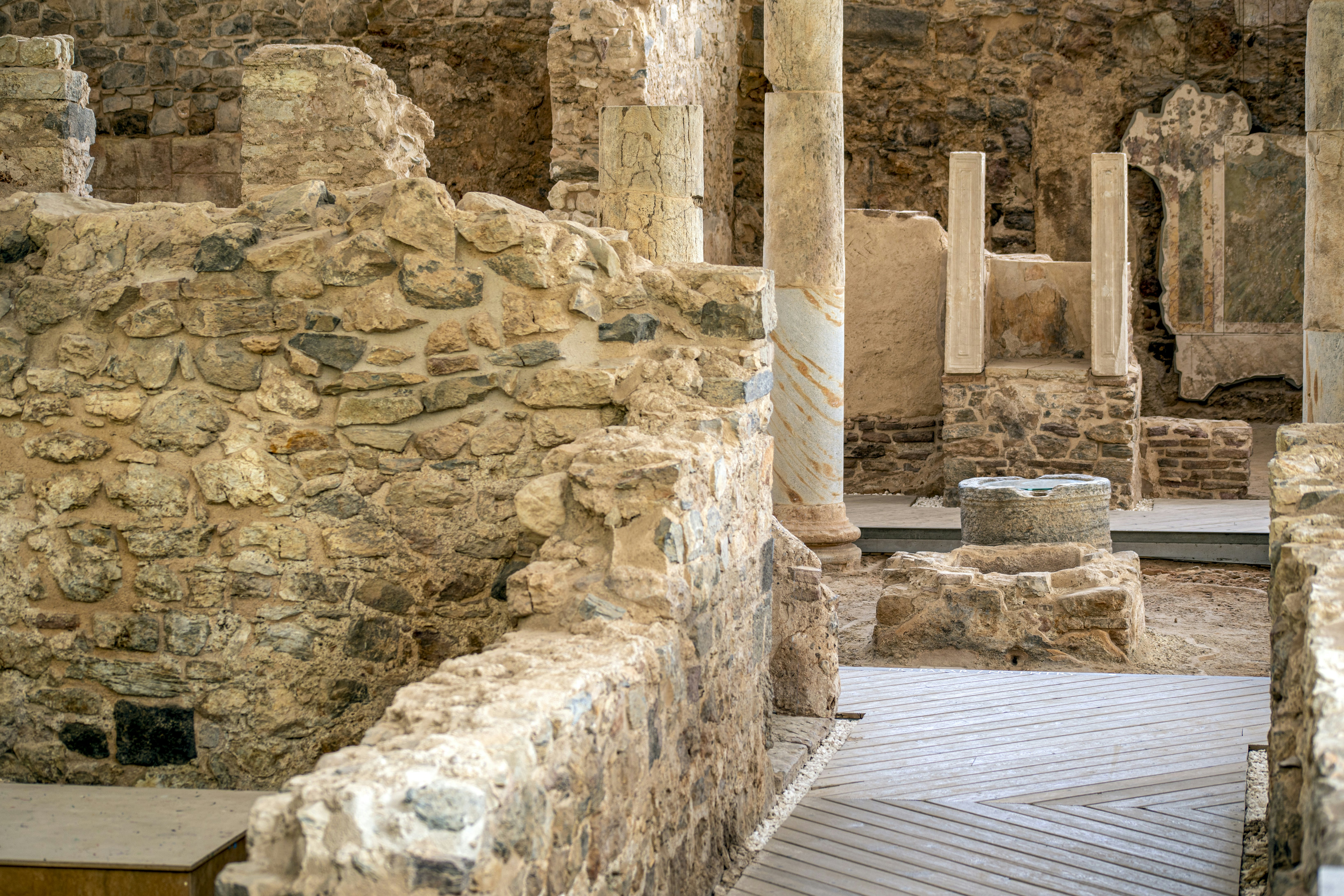 Columns and cobblestone streets in the archaeological area of the Roman forum of El Molinete, Cartagena, Spain.
